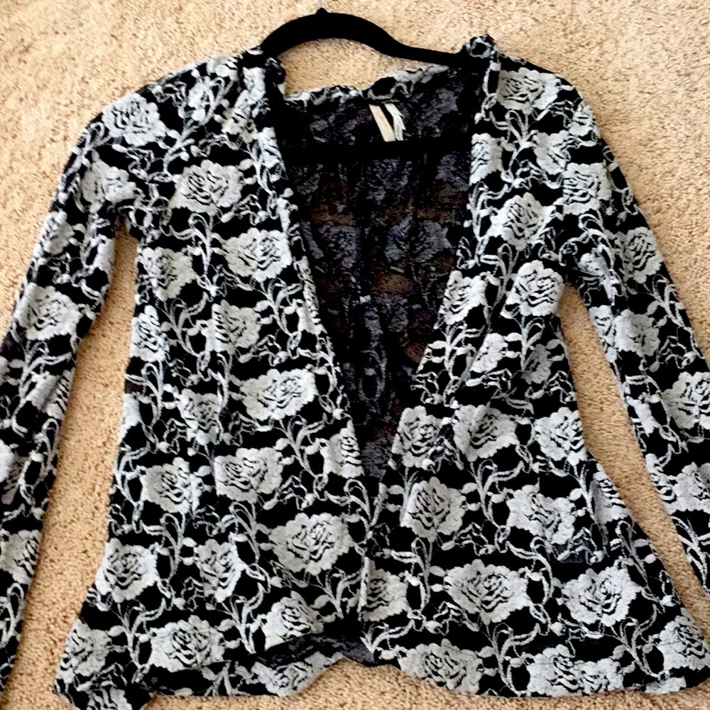 A black and white cardigan with flower designs